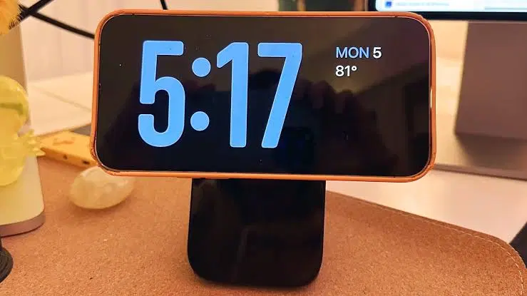 iPhone in StandBy mode displaying the dual-widget layout